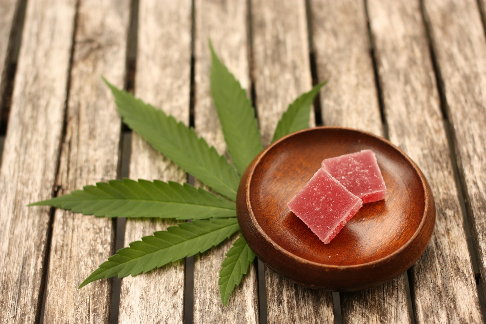 Cannabis edibles arranged on a wooden surface